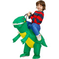 Child wearing green inflatable dinosaur costume with yellow belly and blue pants, holding dinosaur reins.