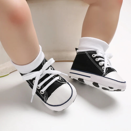 Black Classic Canvas baby sneakers being worn