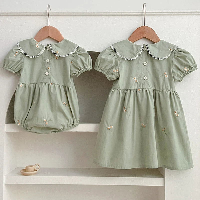 Baby Girl Wearing Green Embroidered Dress and Romper