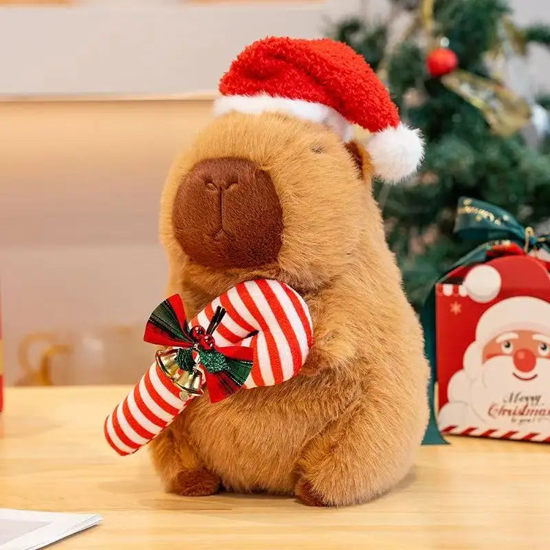 Christmas capybara plush figure wearing a Santa hat and holding a striped candy cane
