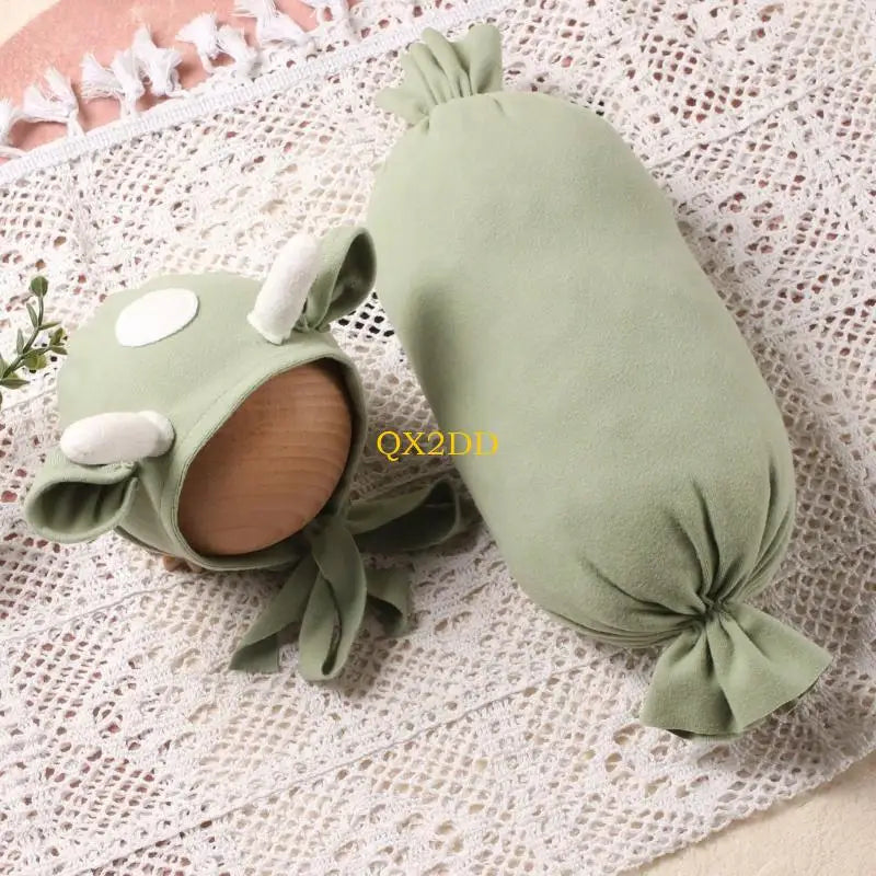 Green cow hat with ears and horns and green plush pillow