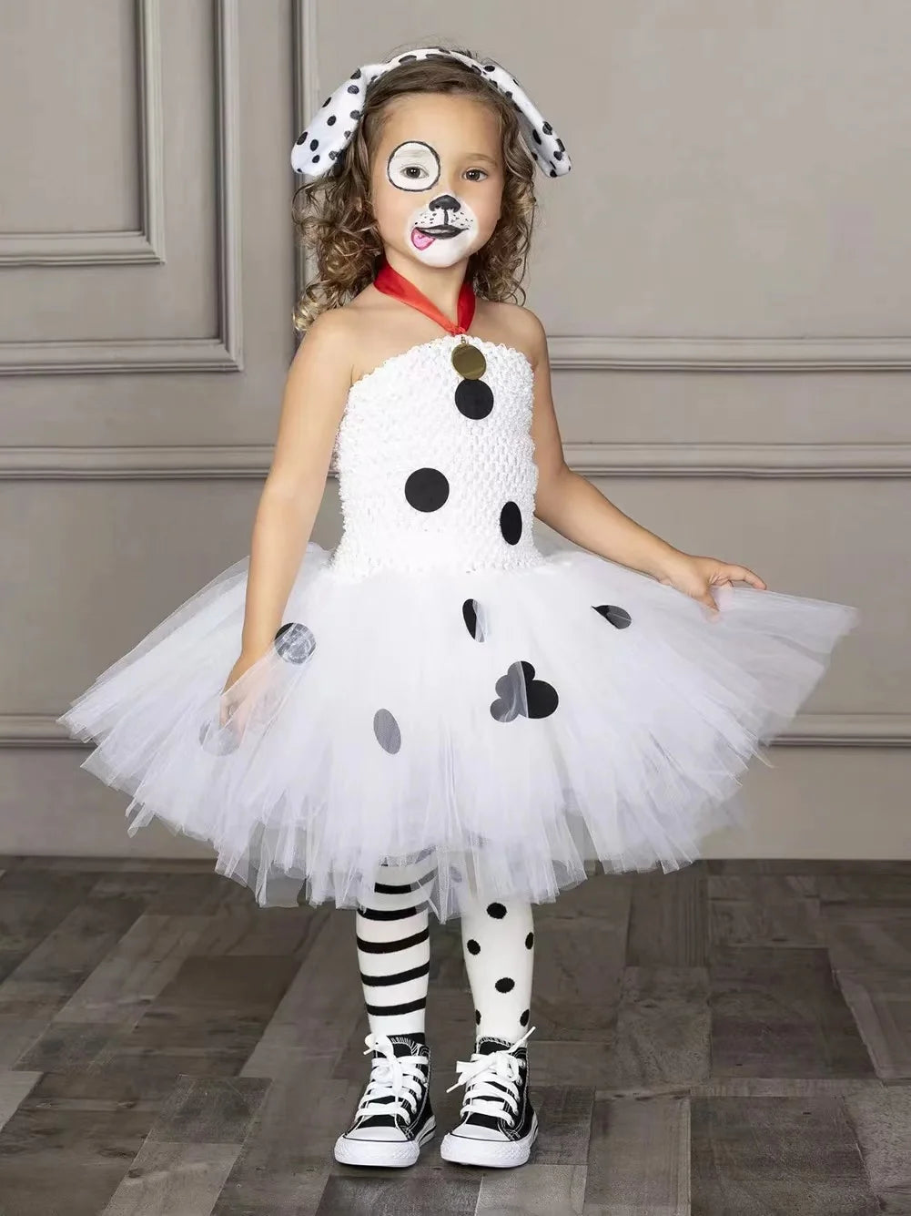 Child wearing white Dalmatian dog tutu dress costume with spotted leggings and dog ear headband