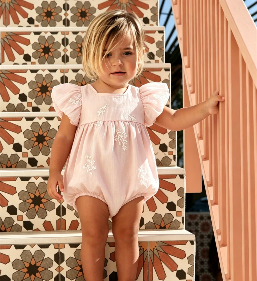 Pink embroidered short sleeve baby romper with floral design