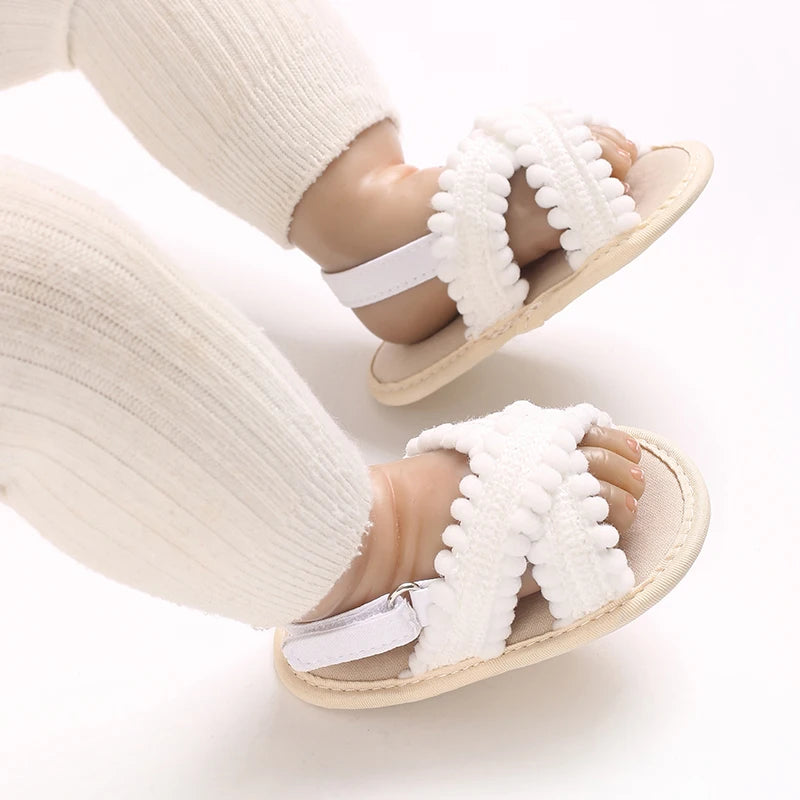 White Scalloped soft sole baby sandals being worn