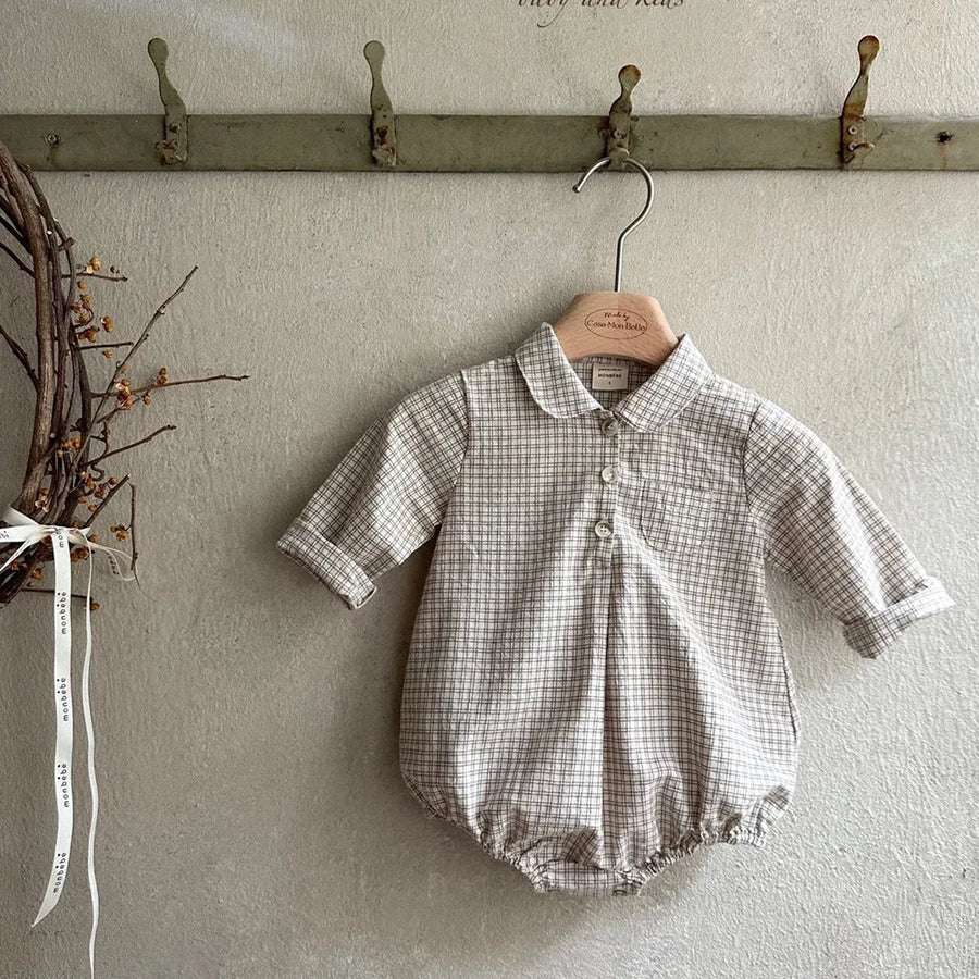 Khaki check long-sleeve baby romper displayed on a wooden hanger