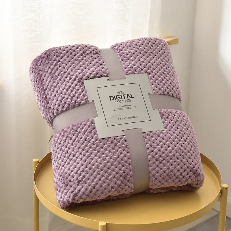 Folded thick quilted baby blanket in pastel colors