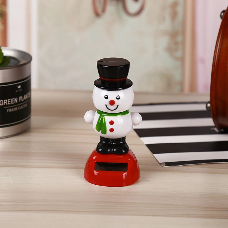 White snowman Christmas solar bobblehead with a black top hat, green scarf and red base