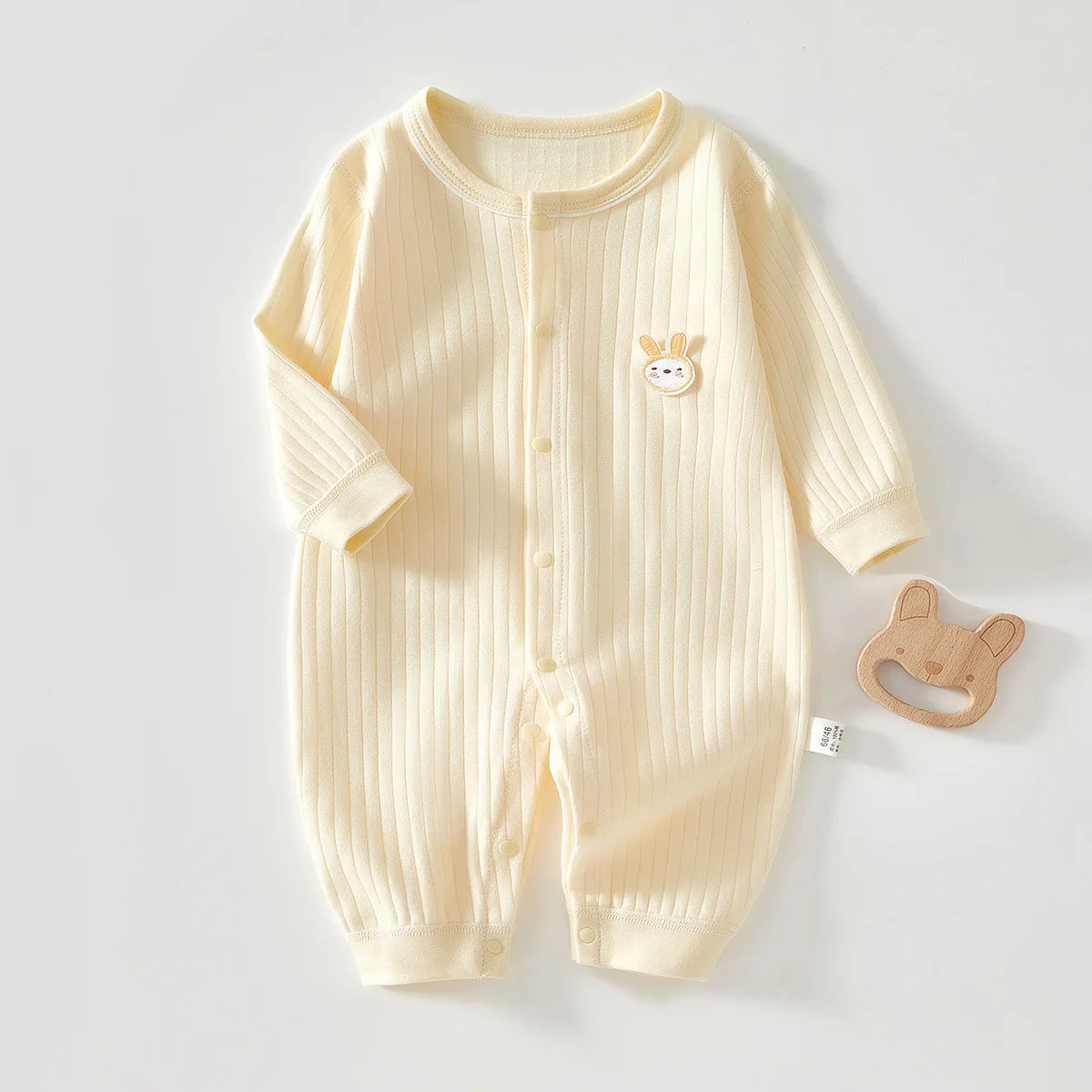 Close-up of knit fabric and single-breasted closure on romper