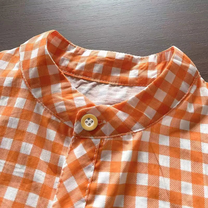Turn-down collar and top buttons on orange plaid shirt