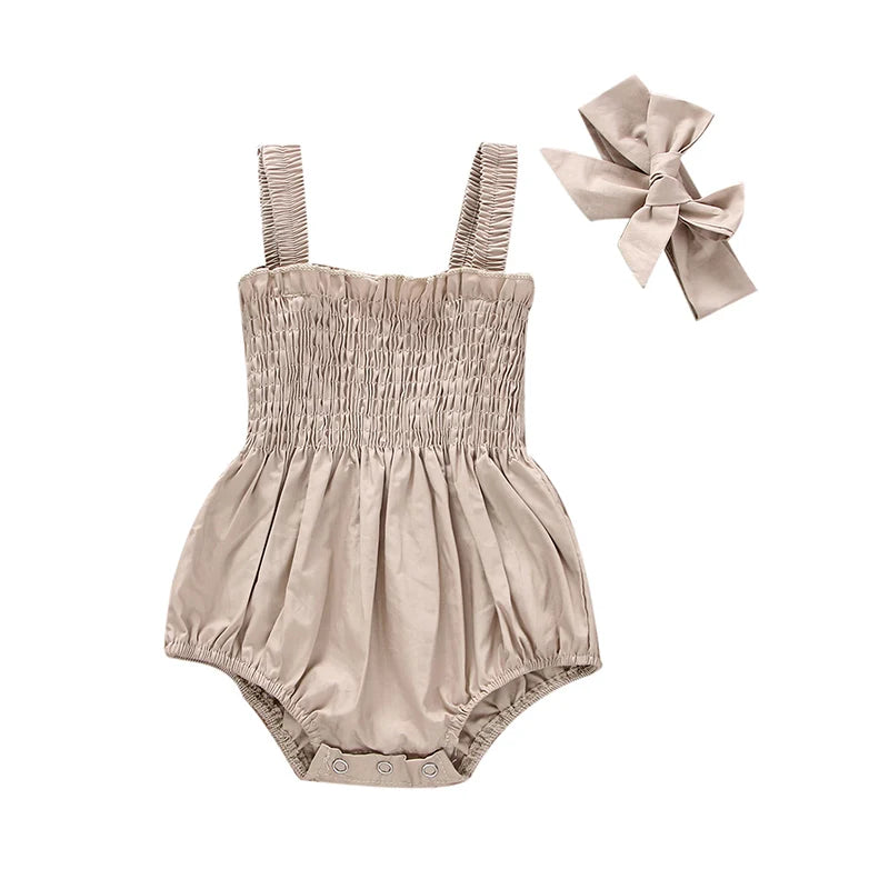 Ruched romper displayed on hanger with headband