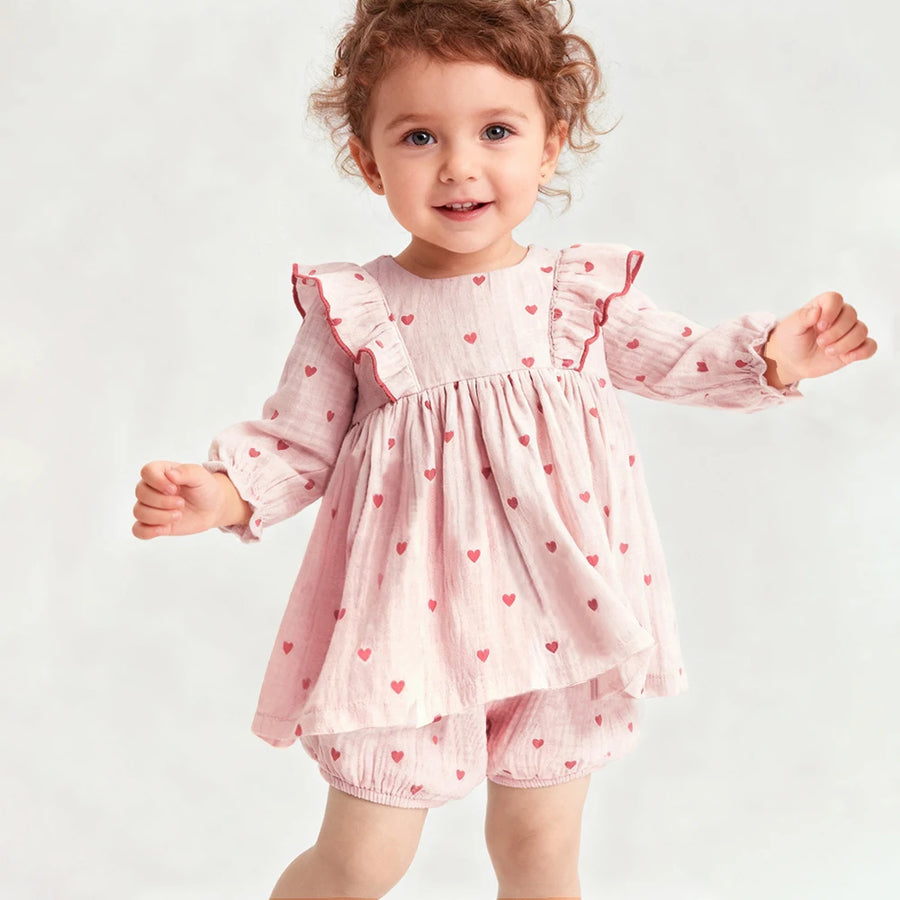 Toddler girl wearing organic cotton long sleeve top and shorts set