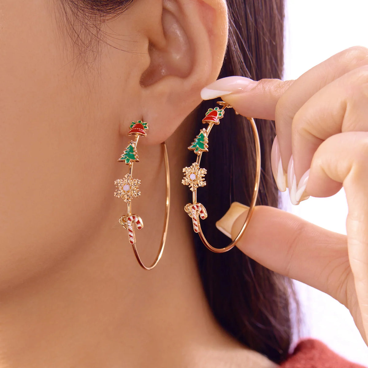 Large hoops decorated with bell, tree, snowflake, and candy cane motifs.