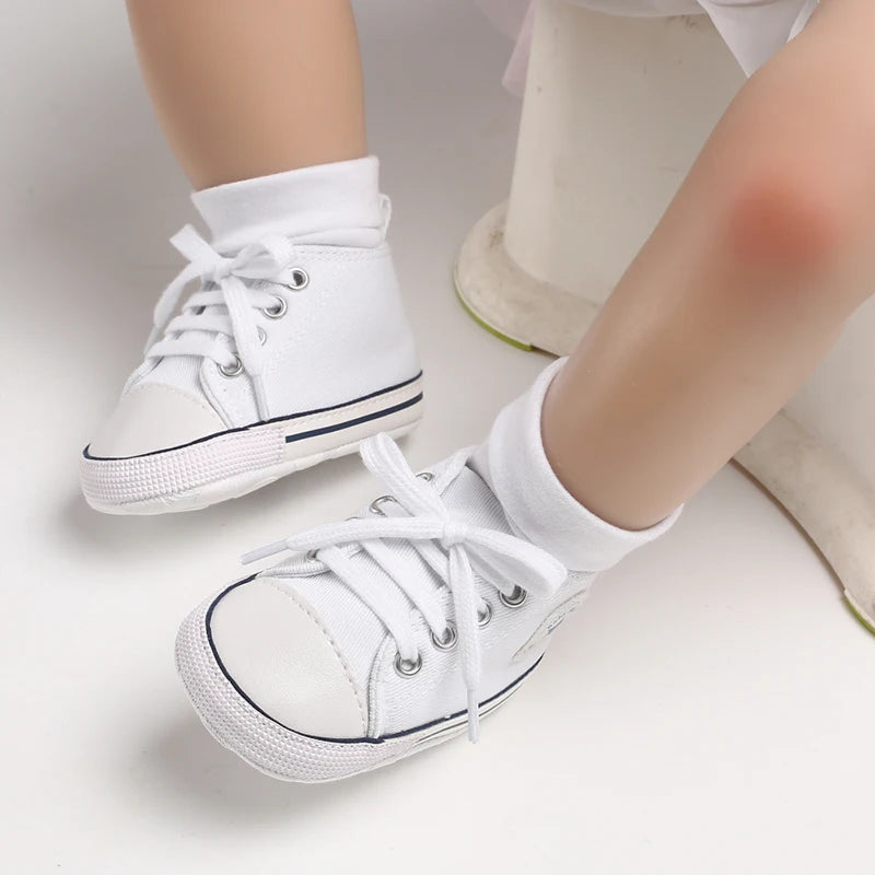 White Classic Canvas baby sneakers being worn