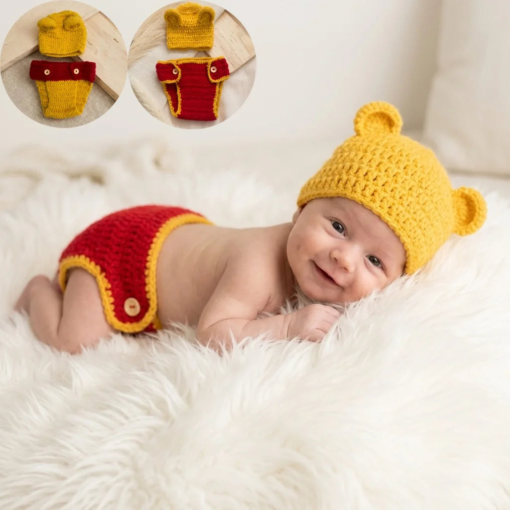 Baby wearing yellow crochet bear hat and red diaper cover