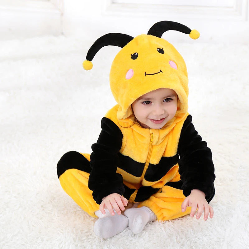 Child wearing yellow bumblebee plush hooded romper costume sitting on white carpet