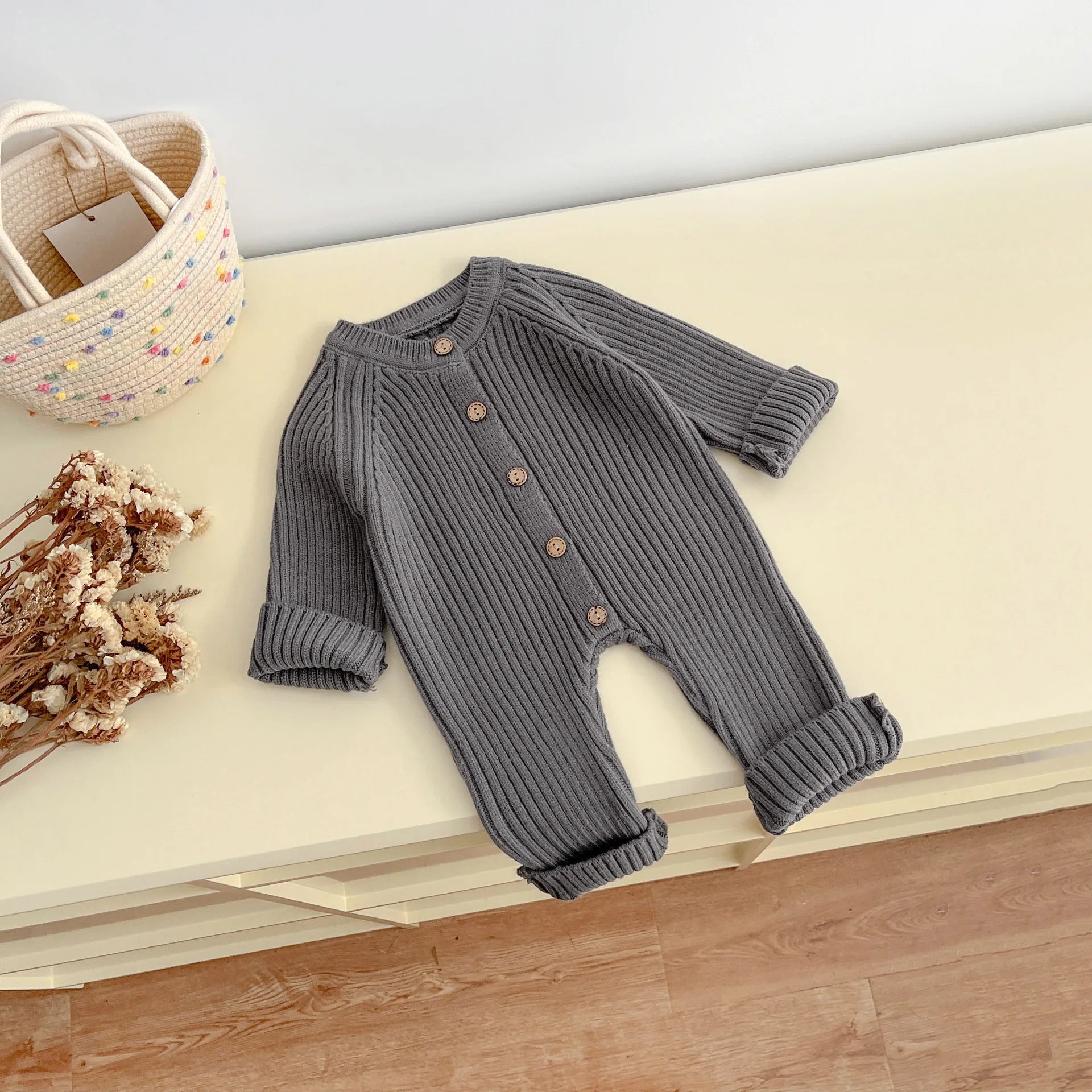 Back view of knitted solid color baby bodysuit