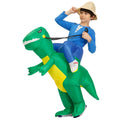 Child wearing inflatable green dinosaur ride-on costume