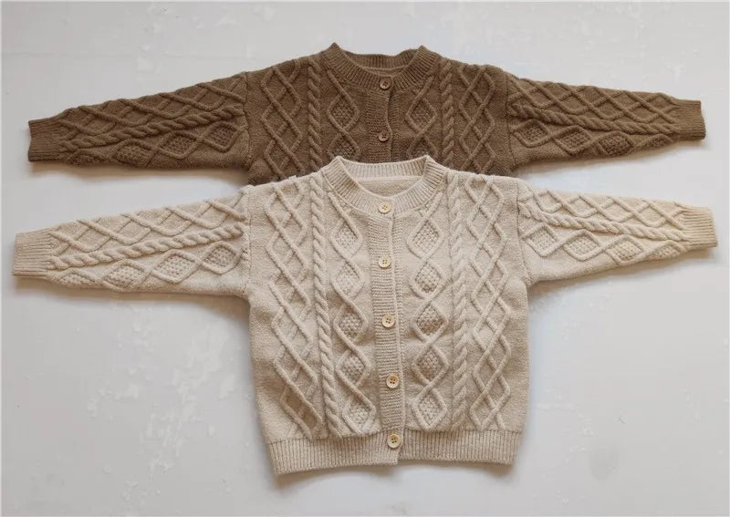 Close-up of twist knit pattern on baby cardigan sweater
