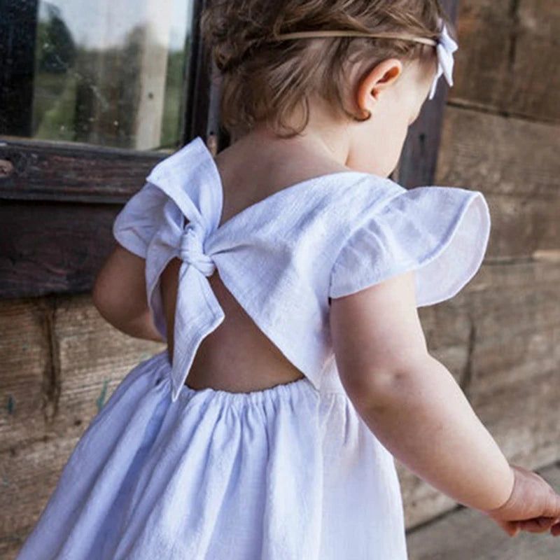 White ruffle-back cotton-linen dress with a tie bow