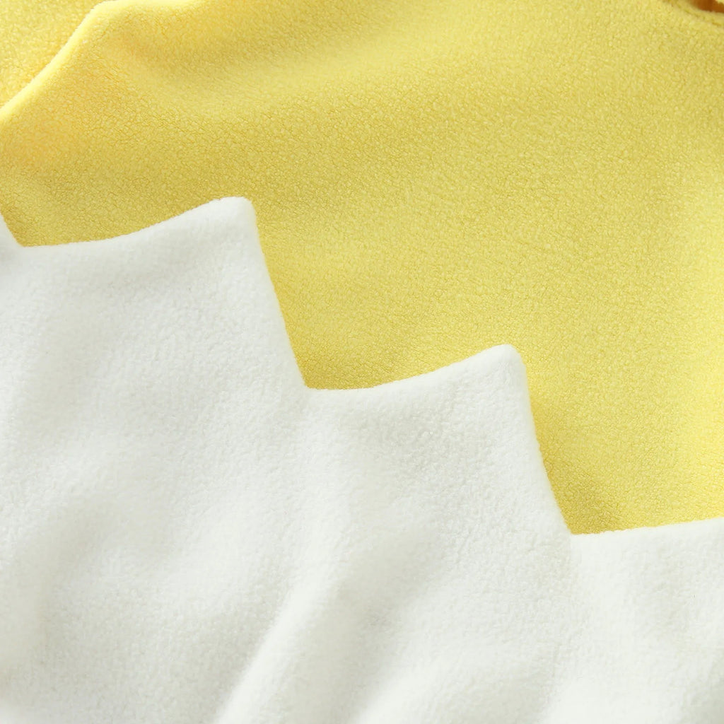 Back view of yellow chick costume romper with white eggshell design and hood