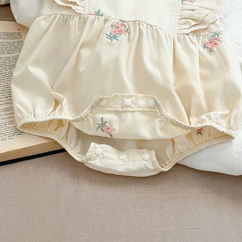 Baby girl wearing sleeveless floral bodysuit outdoors