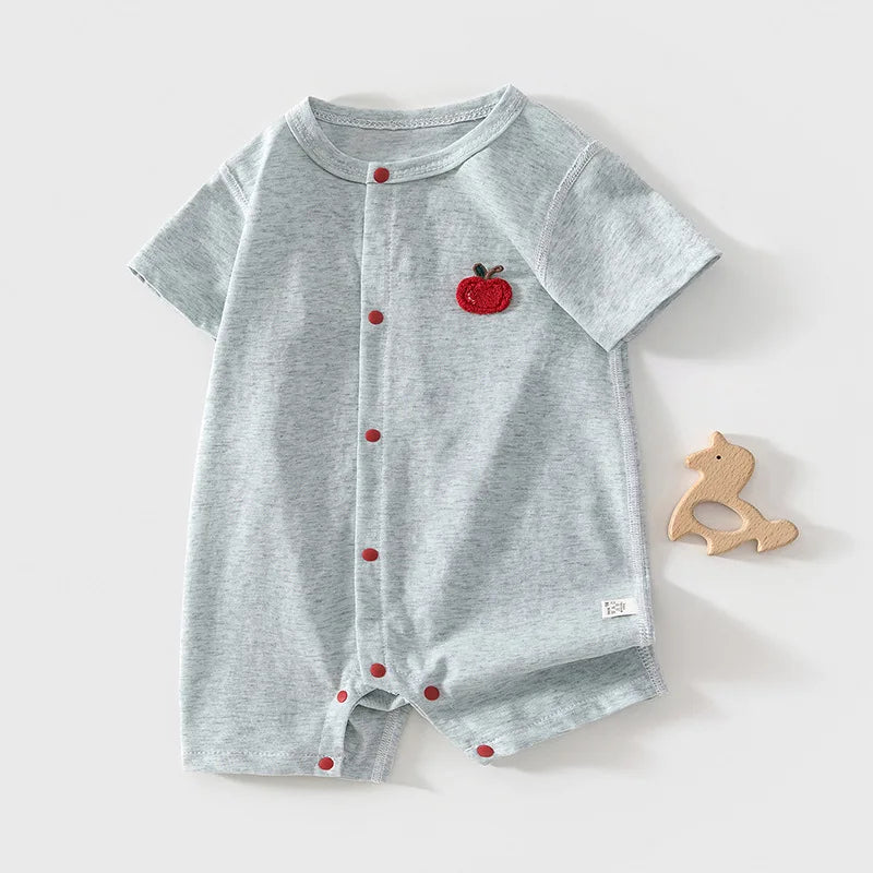 Baby wearing Apple Patch Romper outdoors