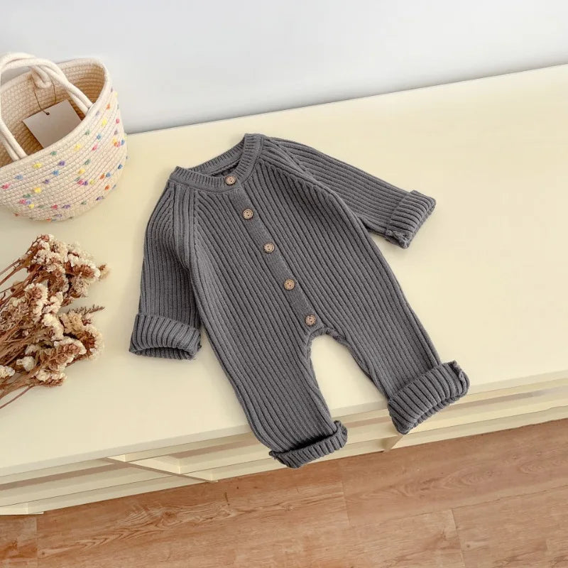 Detail of full sleeve on knitted baby bodysuit
