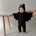 Baby wearing black bat wing costume set with hood and pants