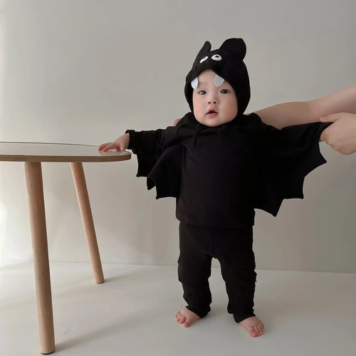 Baby wearing black bat wing costume set with hood and pants