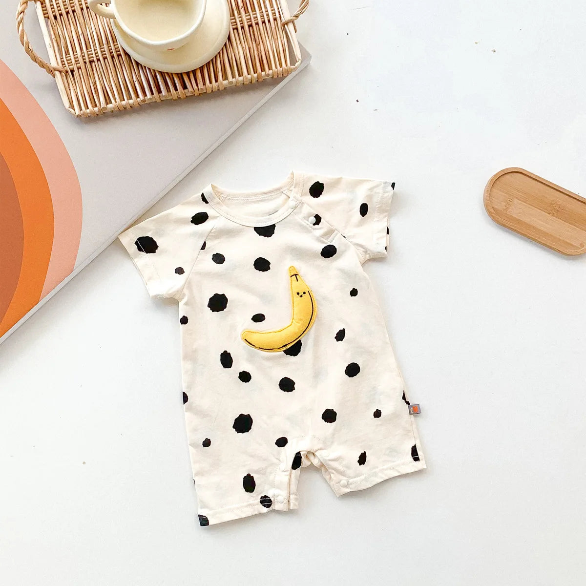 Baby romper displayed on hanger showing design details