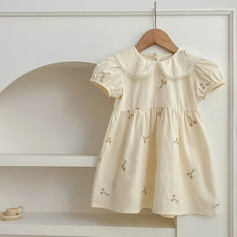 Girls wearing embroidered princess dress and romper set in various colors