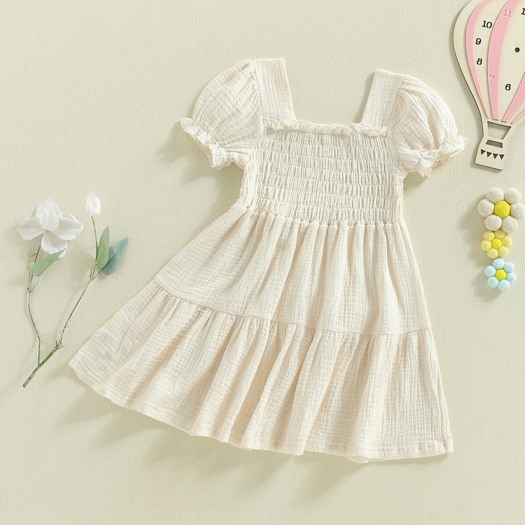 Ivory smocked puff-sleeve dress angled flat lay