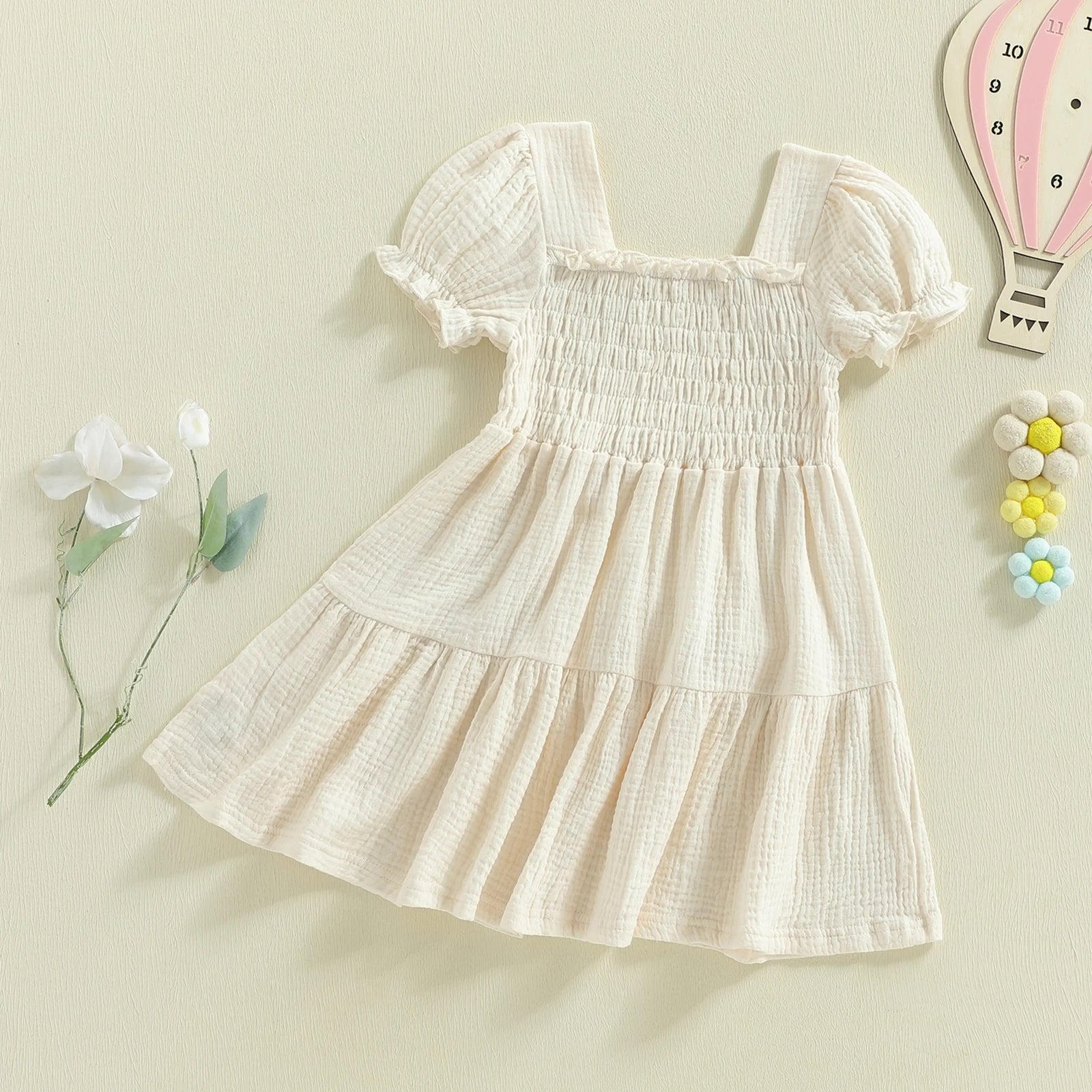 Ivory smocked puff-sleeve dress angled flat lay