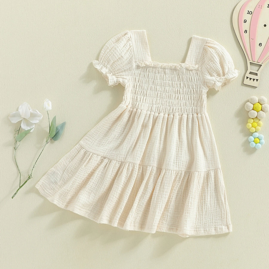 Ivory smocked puff-sleeve dress angled flat lay
