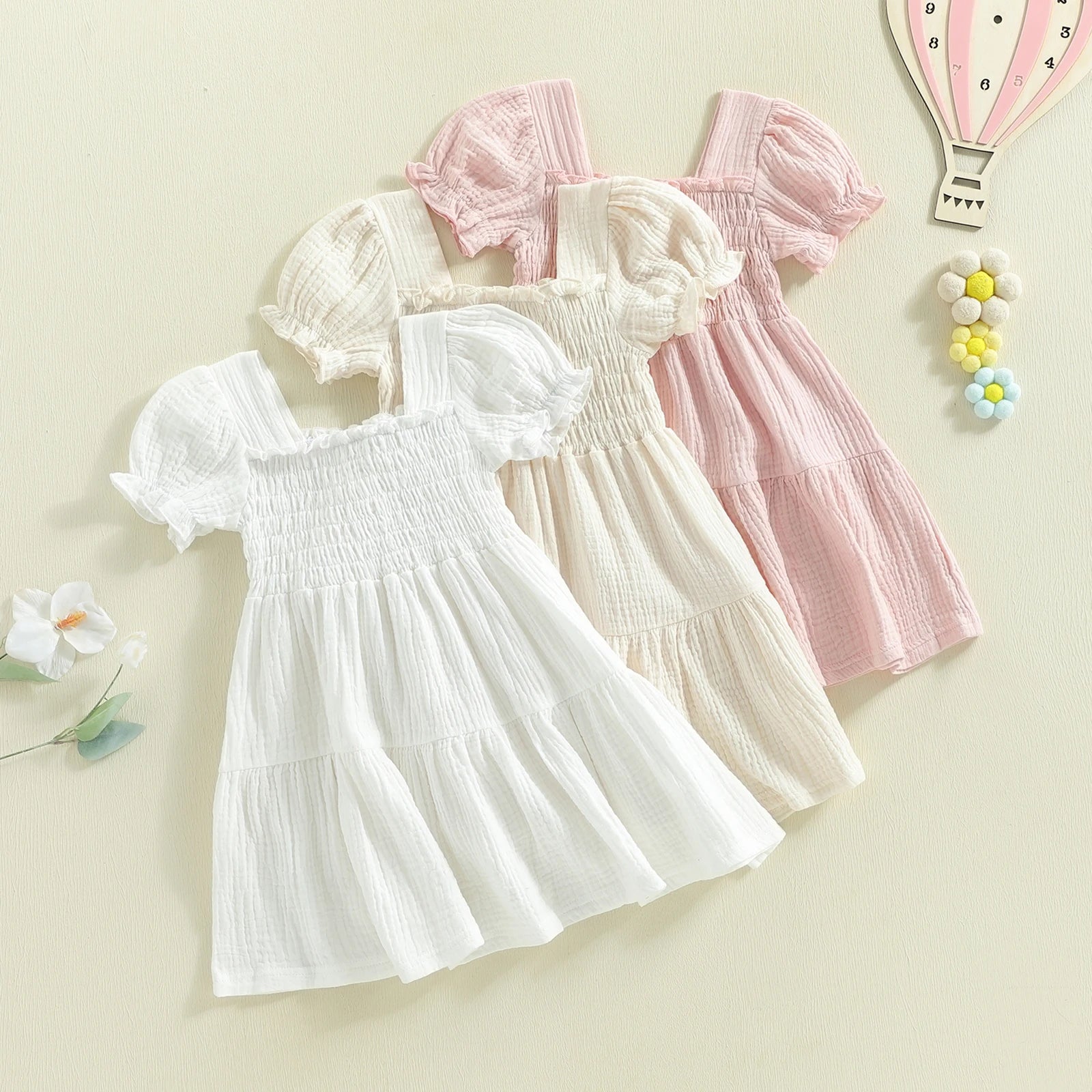 Smocked puff-sleeve dresses in white, ivory, and pink