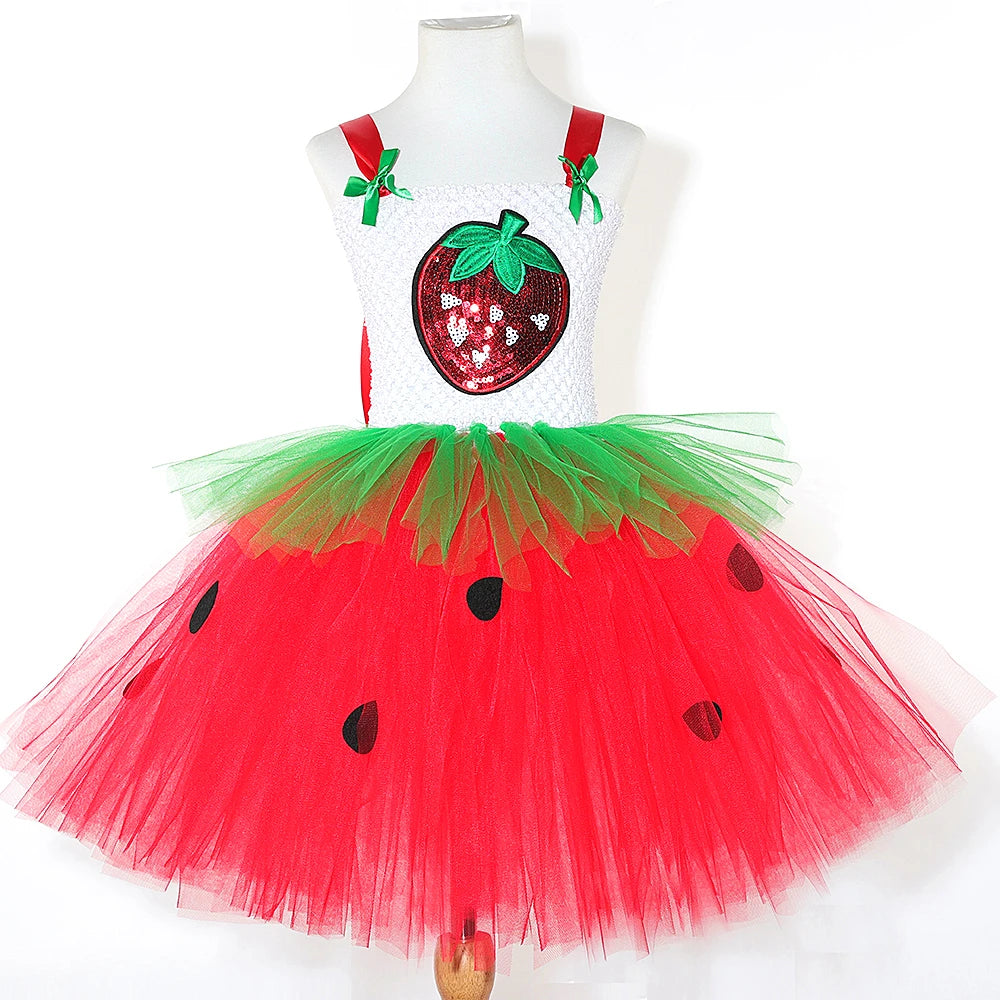 Strawberry tutu dress displayed on mannequin showing white crochet top and red tulle skirt with black seed appliques