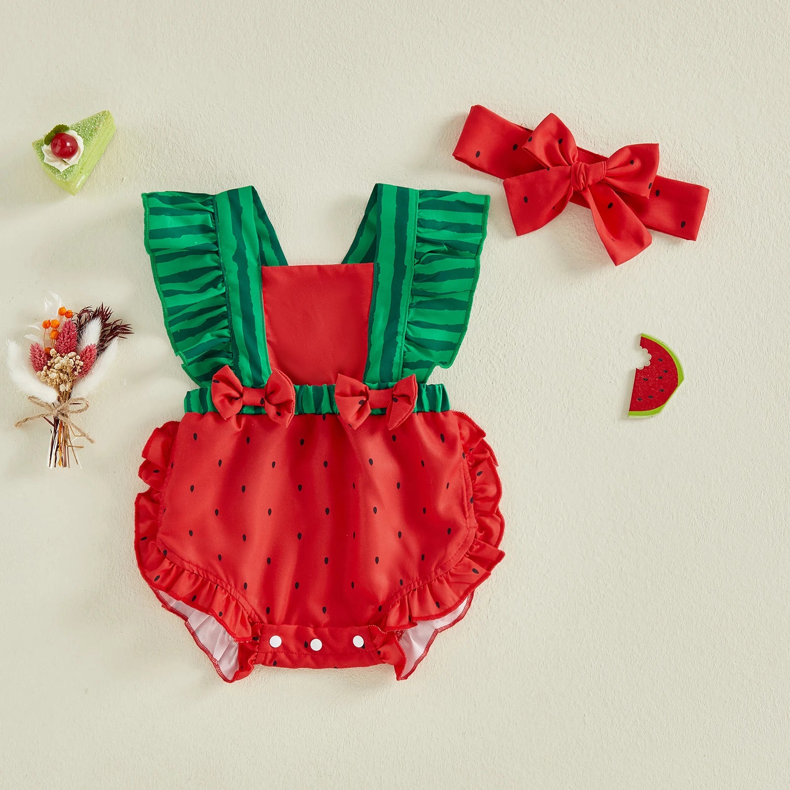 Infant girl watermelon-themed romper with green ruffled straps and matching red bowknot headband