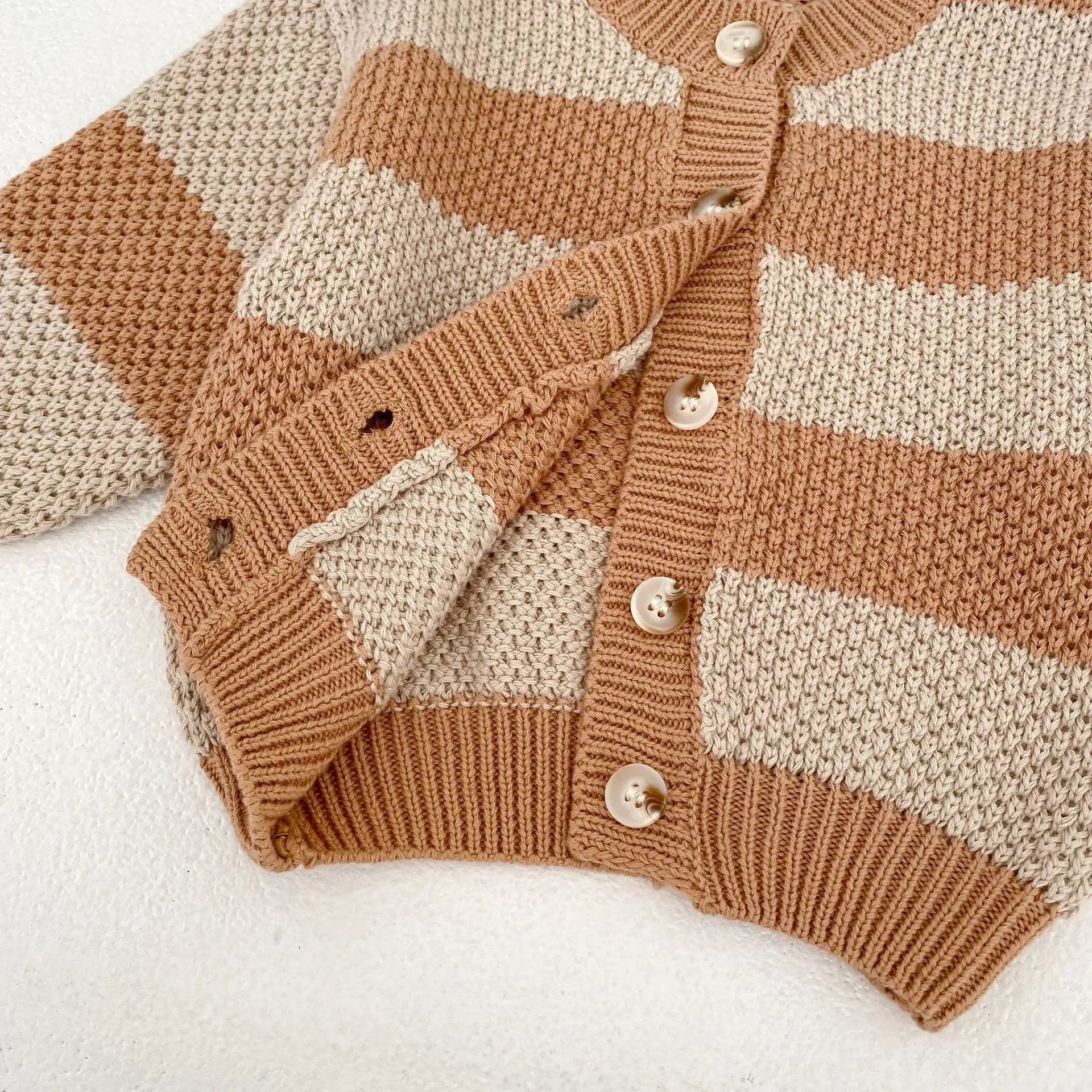 Striped knitted cardigan sweater jacket detail showing soft cotton fabric