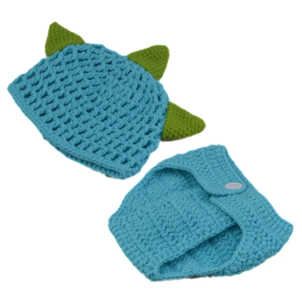 Blue knitted baby hat with green dinosaur spikes and matching diaper cover