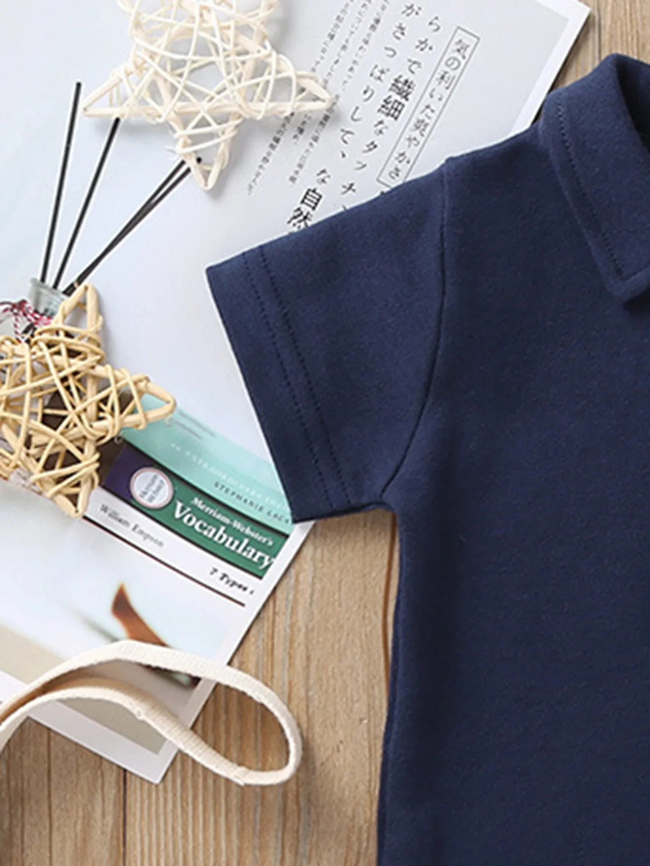 Baby wearing Solid Polo Romper outdoors