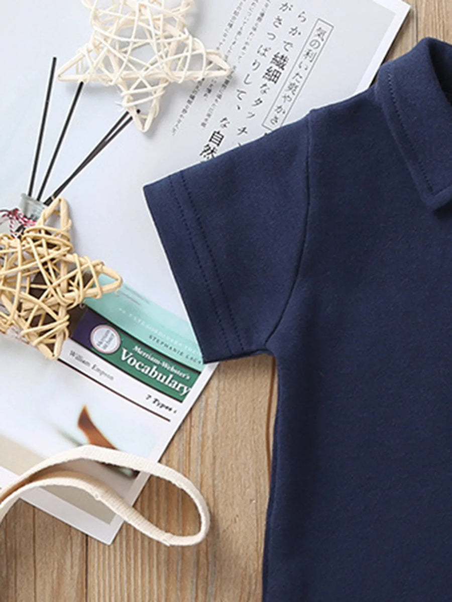 Baby wearing Solid Polo Romper outdoors