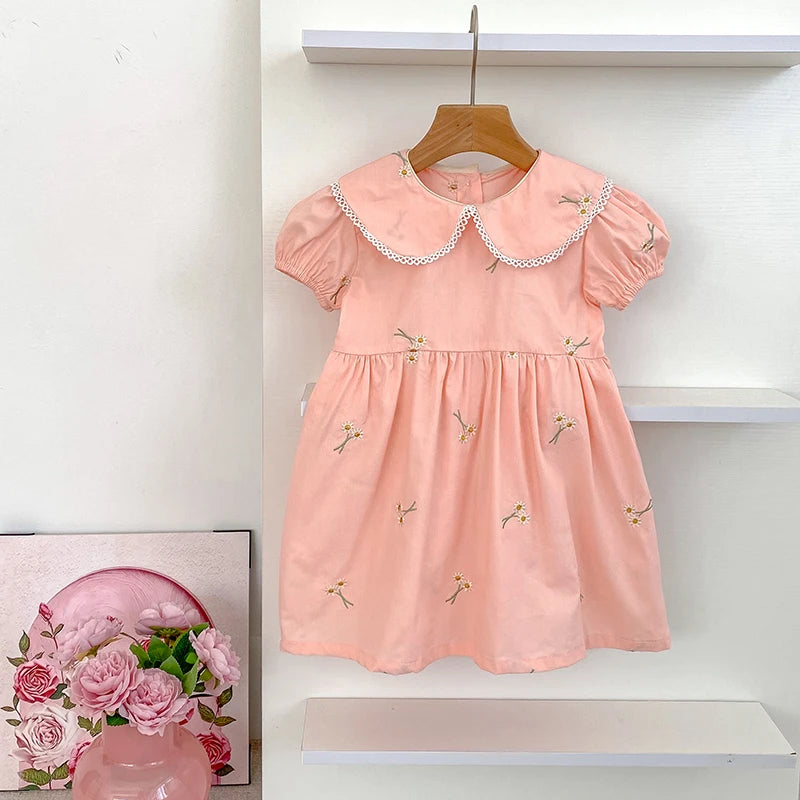 Pink embroidered romper and dress set for girls displayed on hanger