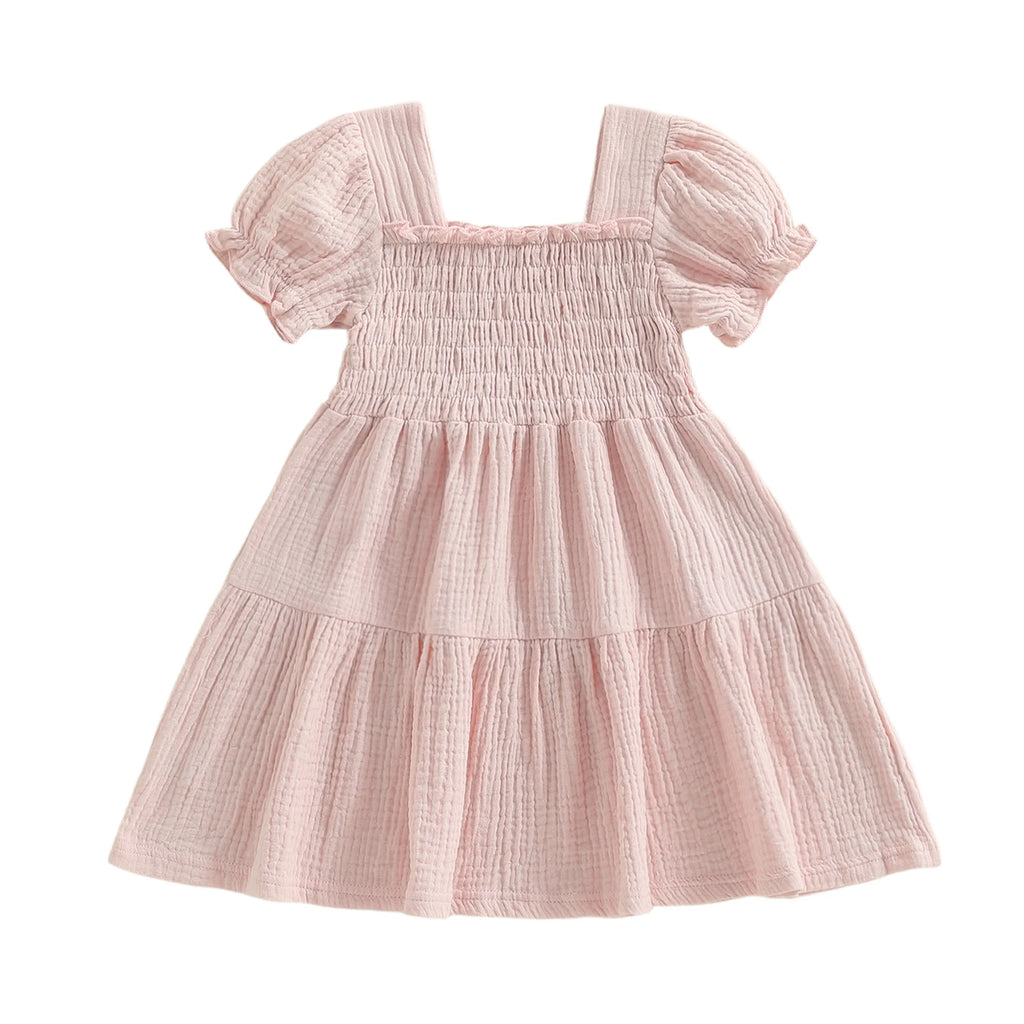 Pink smocked puff-sleeve dress on white background