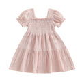 Pink smocked puff-sleeve dress on white background