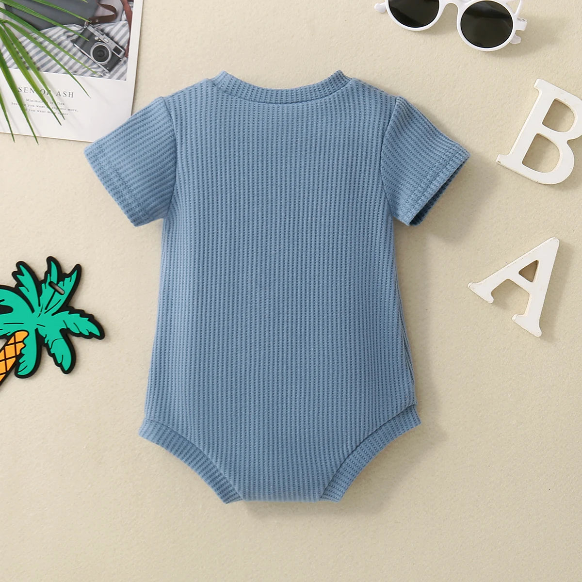 Front view of Embroidered Triangle Romper in Sky Blue