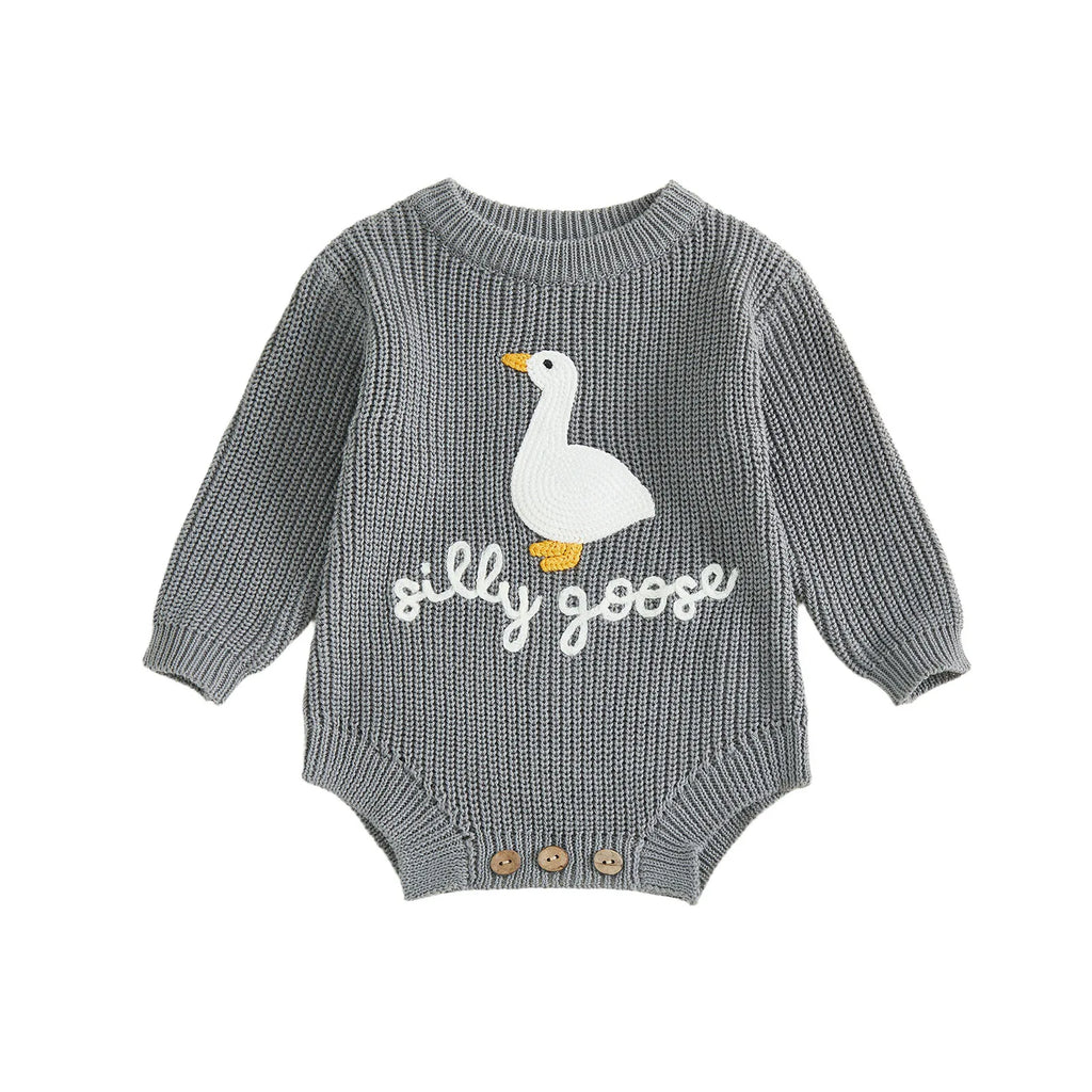 Detail of round neck and long sleeves on knitted baby romper