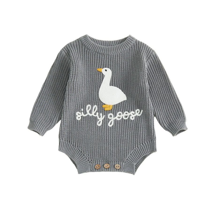 Detail of round neck and long sleeves on knitted baby romper