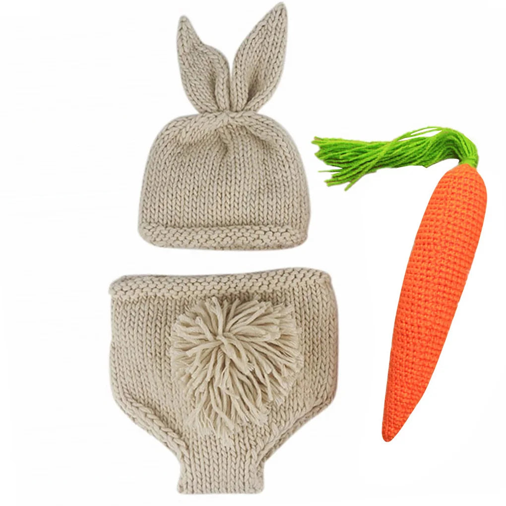 Knitted baby costume set with bunny ear hat, pants with pom-pom tail, and crocheted carrot accessory