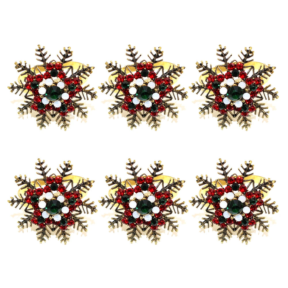 Christmas Wreath Snowflake Napkin Rings — Set of 6. A gold-tone snowflake surrounding a green wreath with red and clear accents.