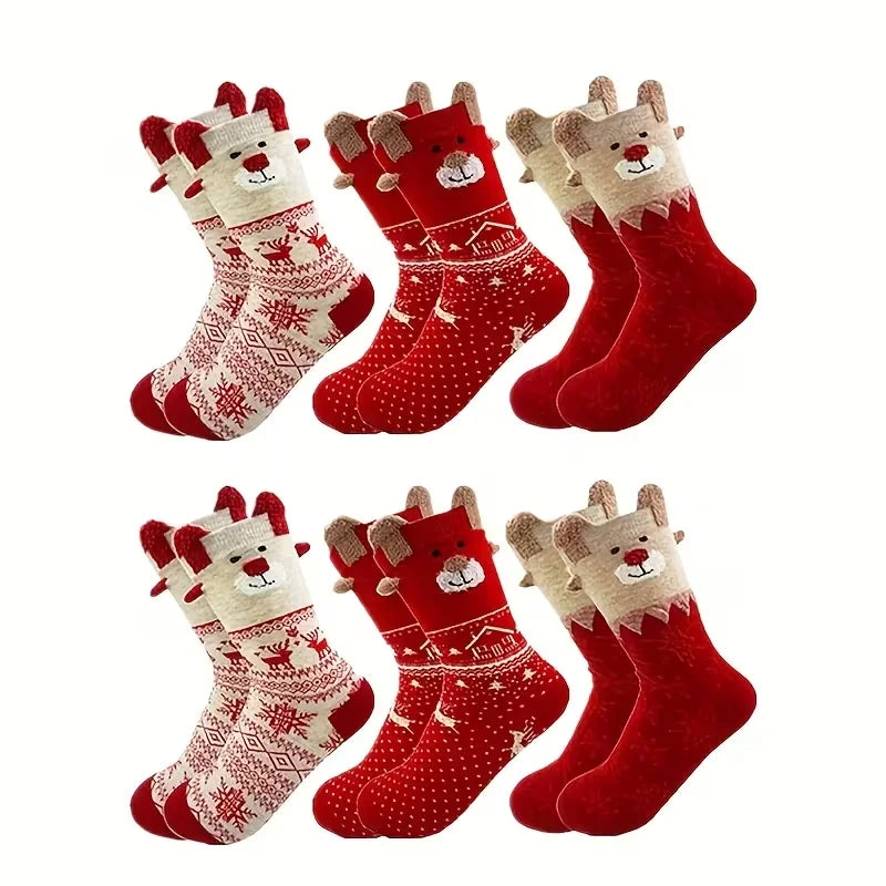 Six pairs of red and cream Christmas socks with reindeer faces and patterned or solid designs, arranged in two rows.